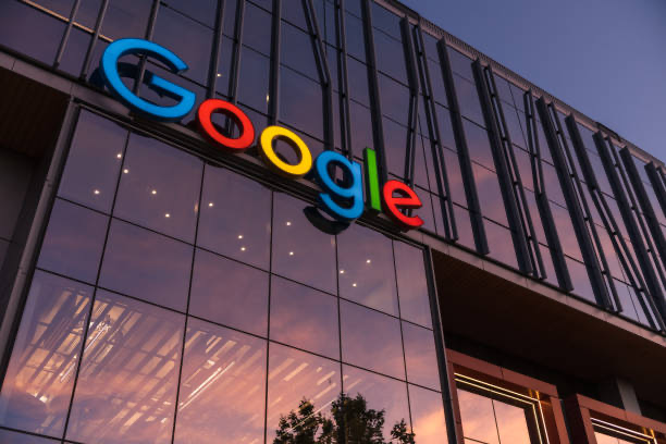 Google building exterior with the Google logo at sunset